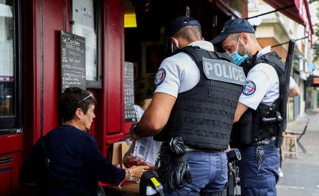 Agents patrol a restaurant area in Paris in a file photo.  /reuters